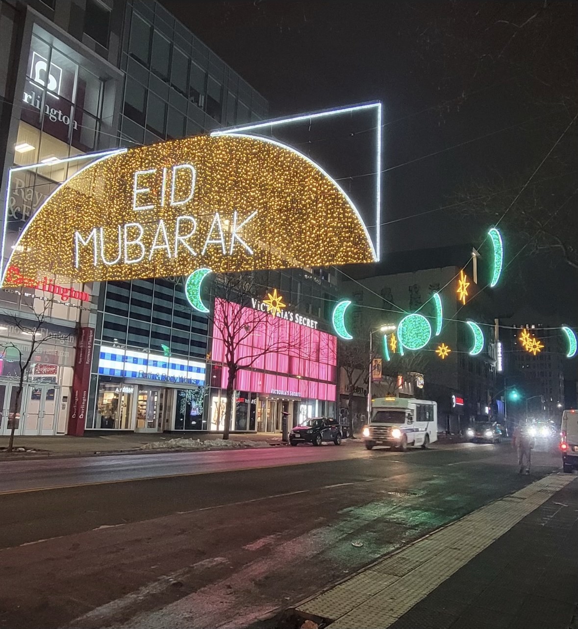 Eid Mubarak illuminated crescent moon and star street display at night